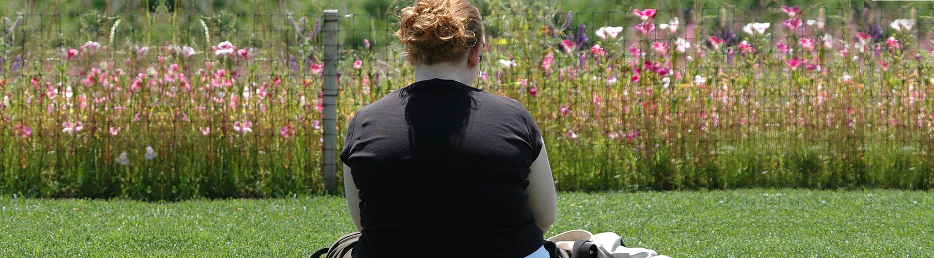 Overweight teenage girl sitting in park